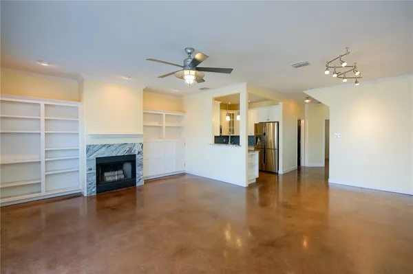wooden floor fireplace and windows in an empty room