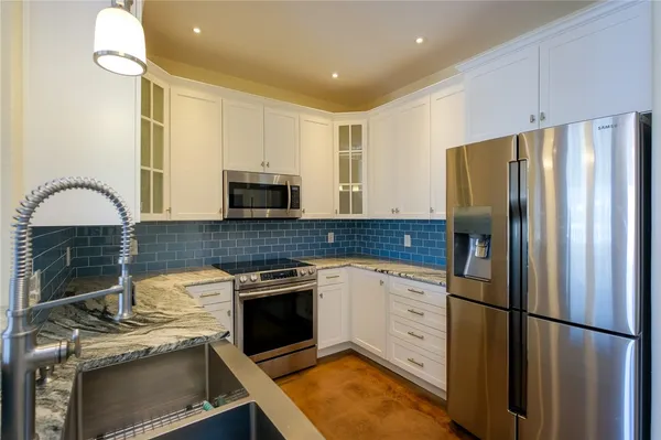 a kitchen with a refrigerator stove and microwave