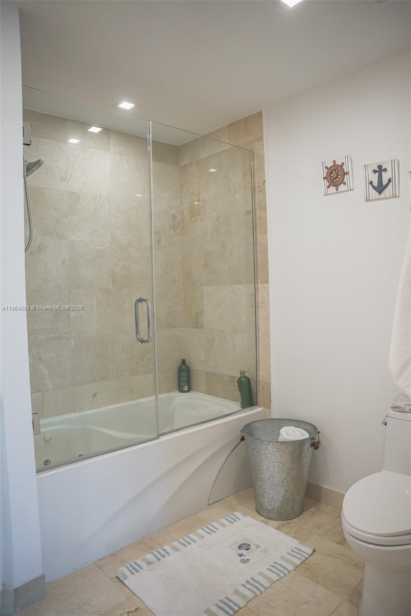 6515 Collins Avenue, Unit 1709 Miami Beach, FL 33141 - Photo 15 of 30 a bathroom with a toilet and a bathtub