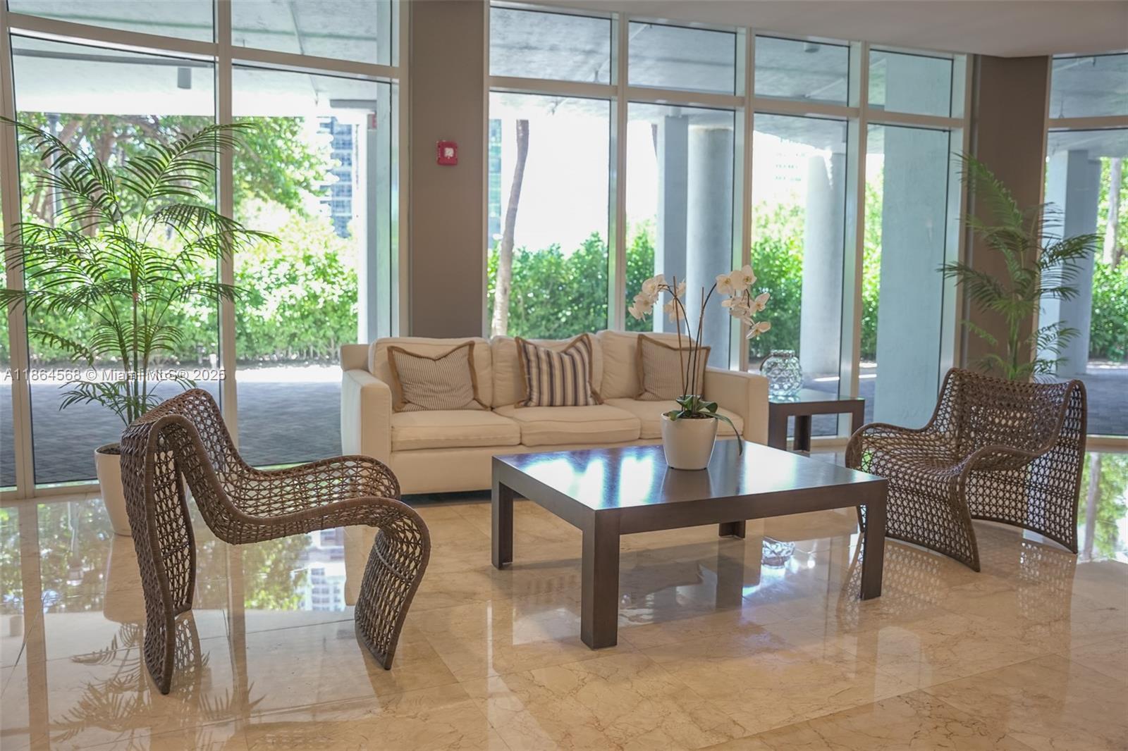 6515 Collins Avenue, Unit 1709 Miami Beach, FL 33141 - Photo 17 of 30 a living room with furniture and a large window