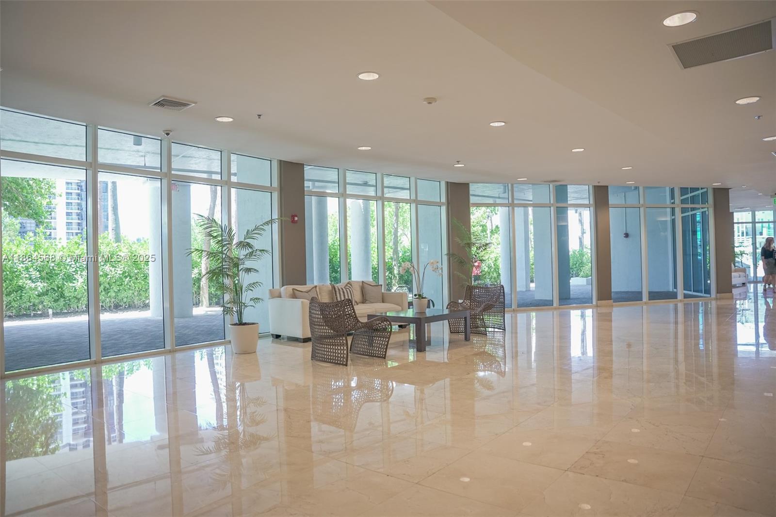 6515 Collins Avenue, Unit 1709 Miami Beach, FL 33141 - Photo 19 of 30 a lobby with furniture and floor to ceiling window