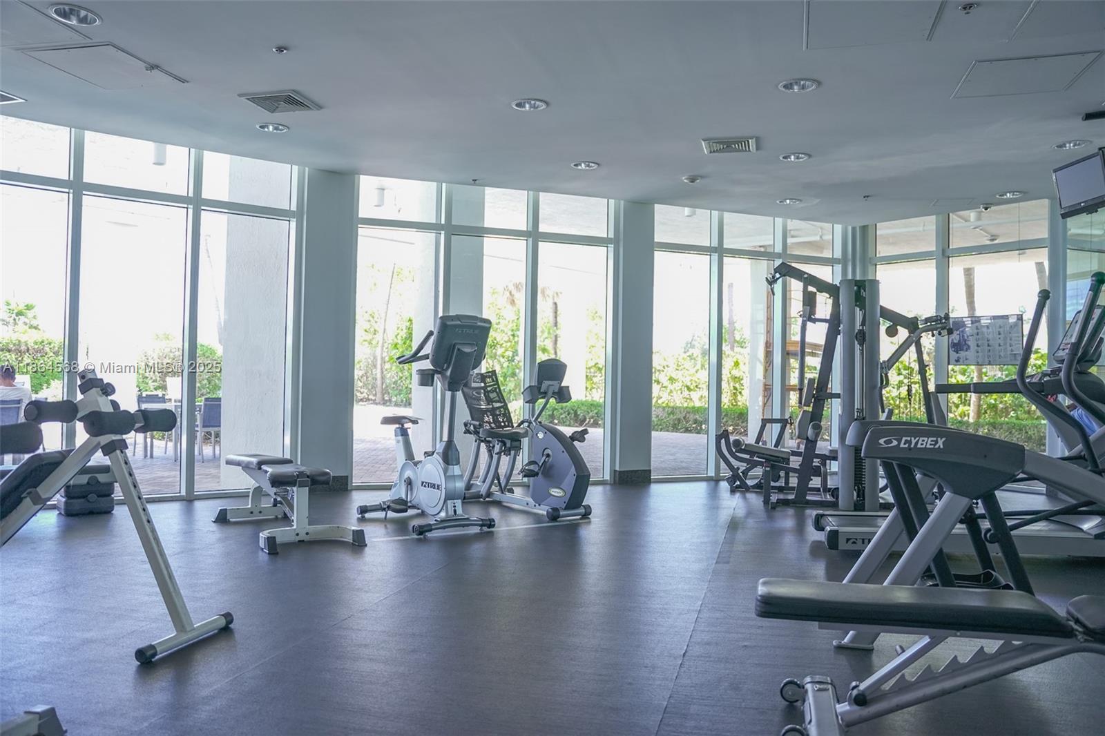 6515 Collins Avenue, Unit 1709 Miami Beach, FL 33141 - Photo 20 of 30 a view of a room with lots of furniture and floor to ceiling windows