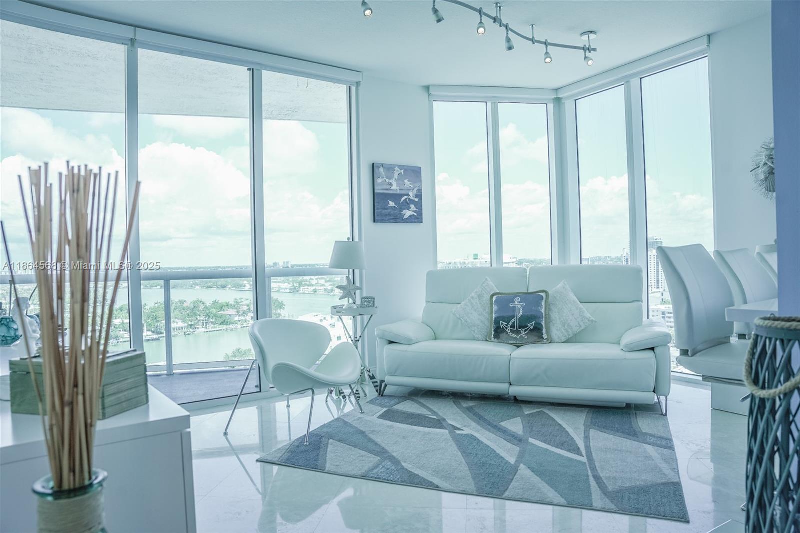 6515 Collins Avenue, Unit 1709 Miami Beach, FL 33141 - Photo 7 of 30 a living room with furniture and a large window