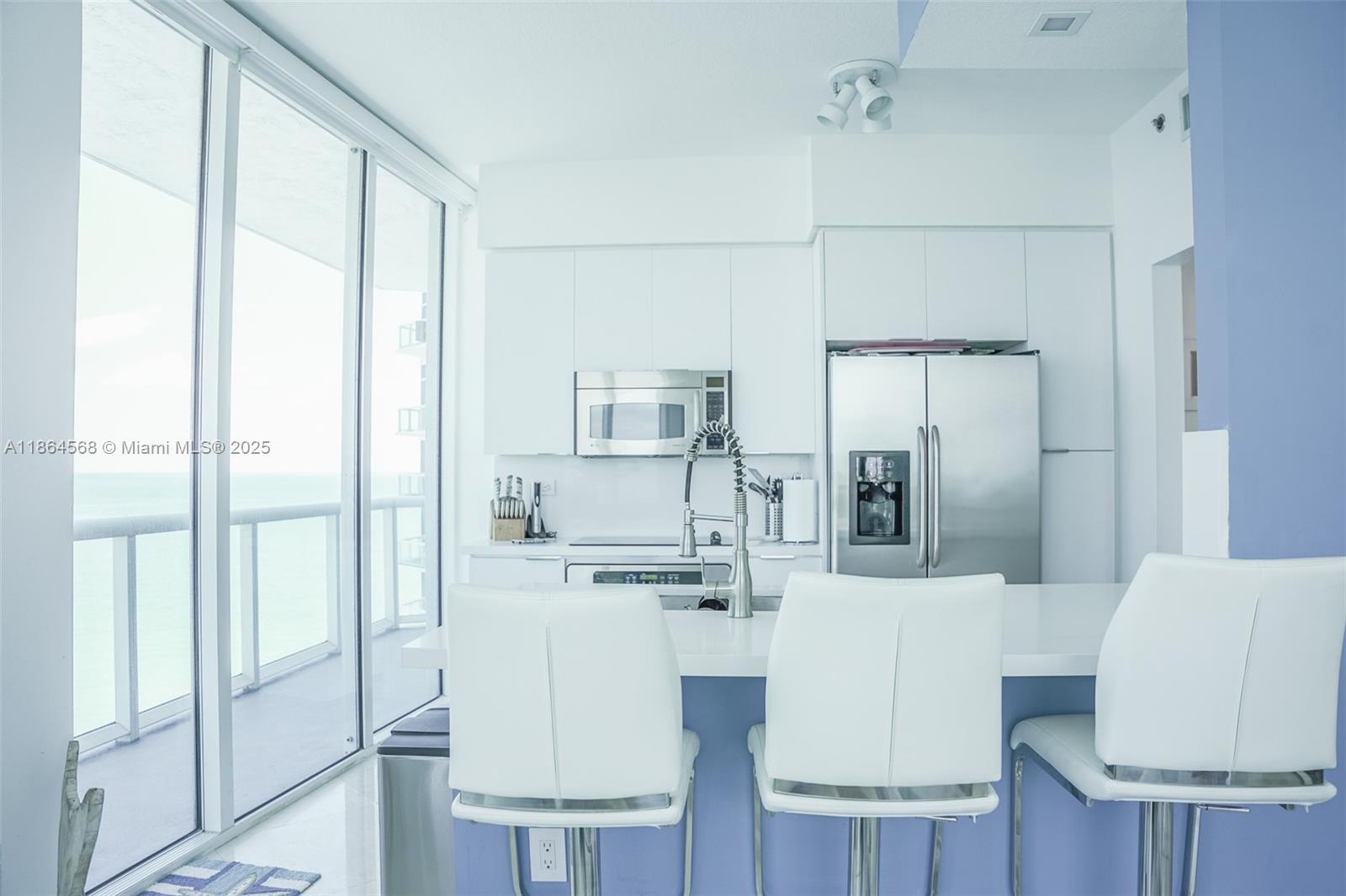 6515 Collins Avenue, Unit 1709 Miami Beach, FL 33141 - Photo 9 of 30 a living room with furniture and a large window
