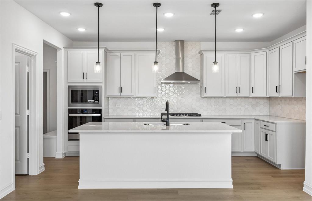 1809 Ridgedale Street Celina, TX 75009 - Photo 12 of 22 *Floorplan representation, not actual home - Spacious kitchen with eat-in bartop island