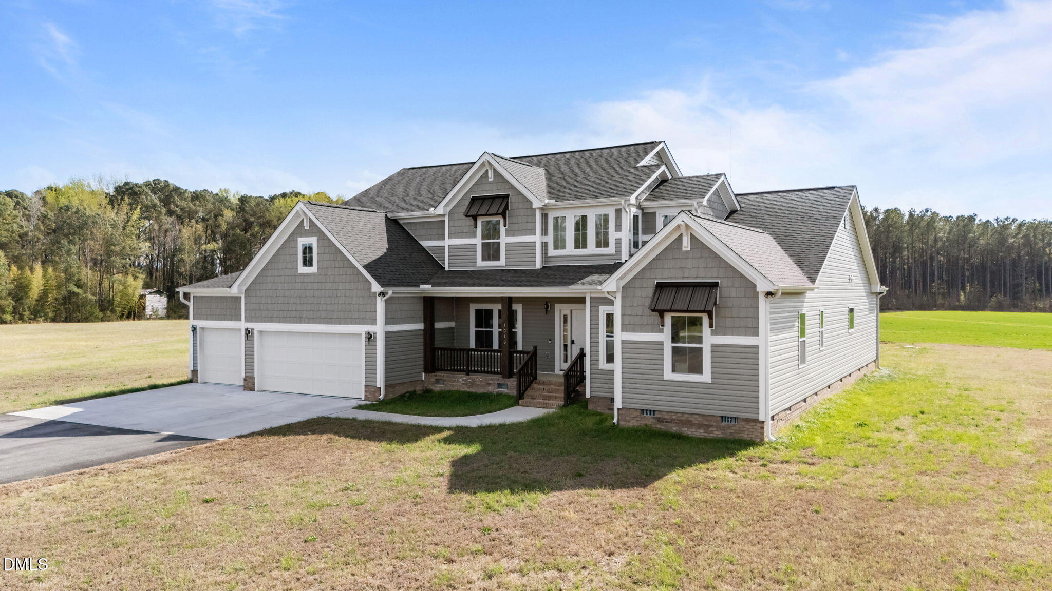 1049 Firetower Road Louisburg, NC 27549 - Photo 14 of 52 a front view of a house with a yard and garage
