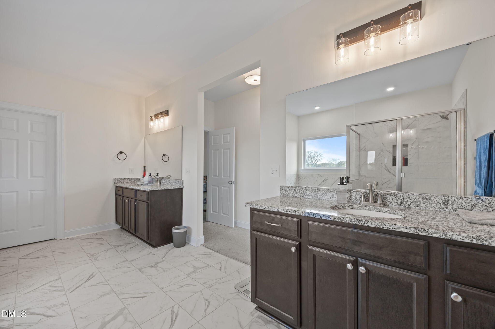 1049 Firetower Road Louisburg, NC 27549 - Photo 26 of 52 a bathroom with a granite countertop double vanity sink mirror and
