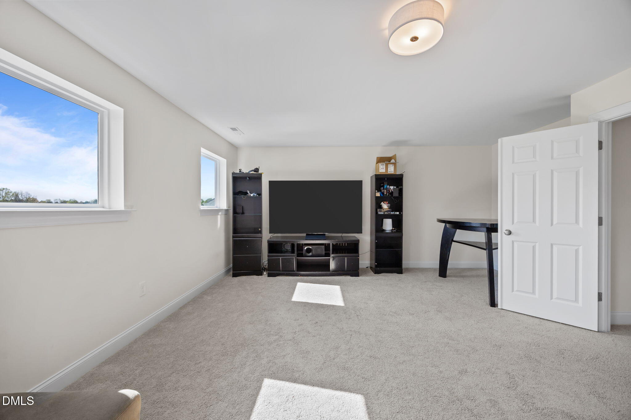 1049 Firetower Road Louisburg, NC 27549 - Photo 30 of 52 a living room with furniture and a flat screen tv