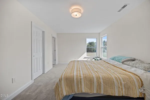 a bedroom with a bed and window