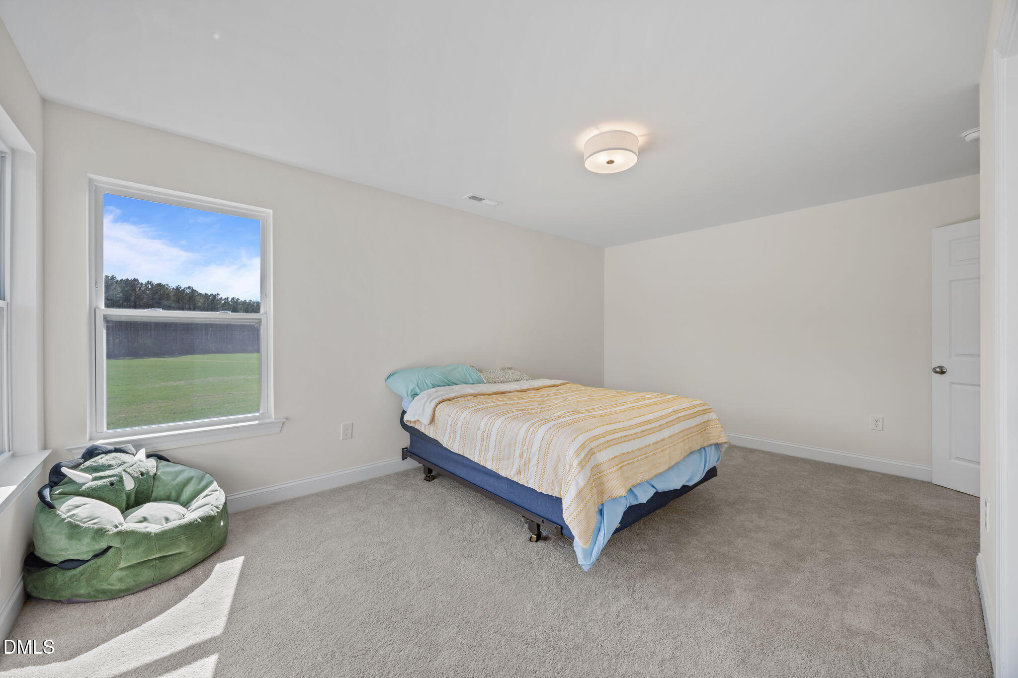 1049 Firetower Road Louisburg, NC 27549 - Photo 34 of 52 a bedroom with a bed and window
