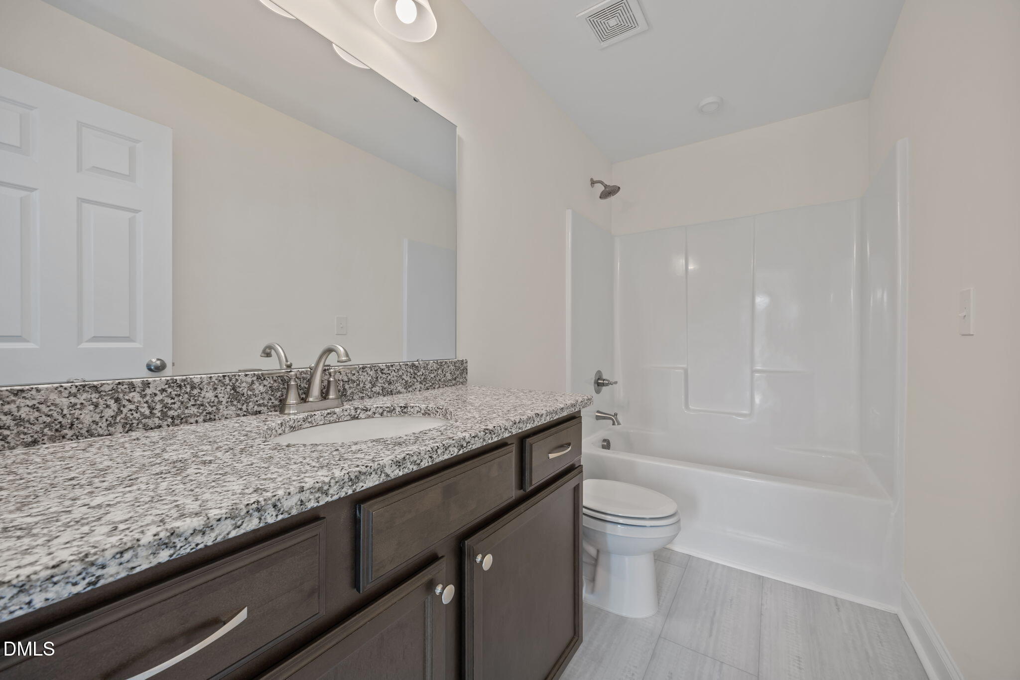 1049 Firetower Road Louisburg, NC 27549 - Photo 36 of 52 a bathroom with a granite countertop sink a toilet and shower