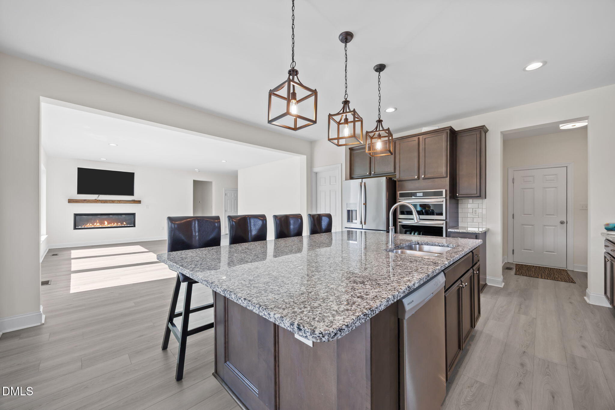 1049 Firetower Road Louisburg, NC 27549 - Photo 6 of 52 a kitchen with stainless steel appliances granite countertop a kitchen island a stove a table and chairs