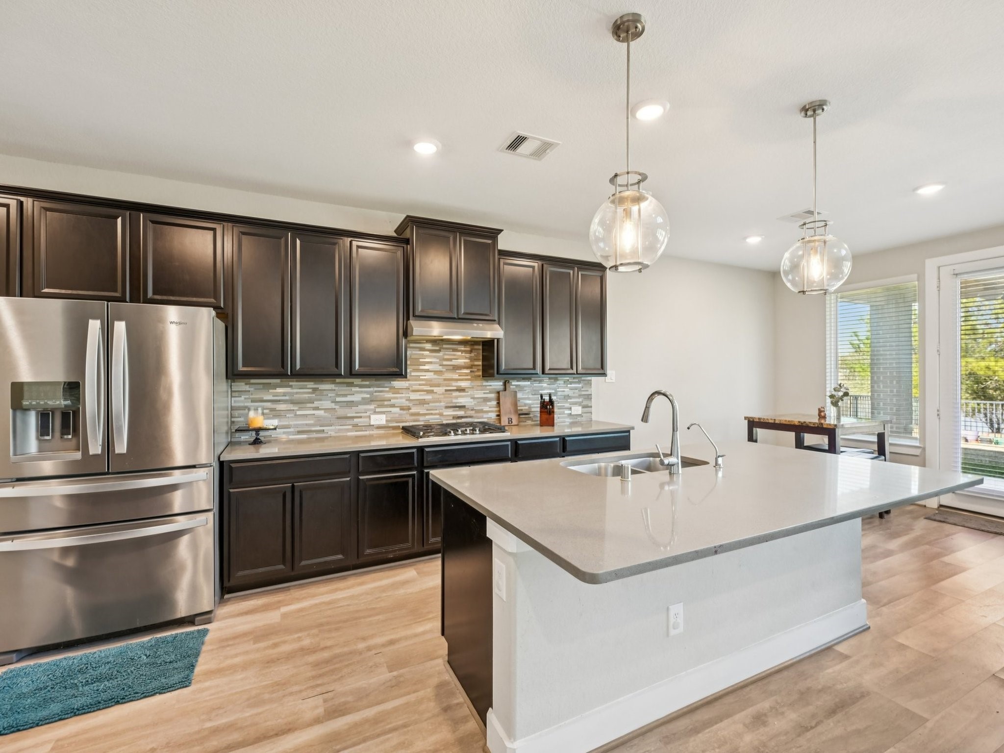 2505 Hatton Terrace Lane Pearland, TX 77089 - Photo 13 of 44 a modern kitchen with stainless steel appliances granite countertop a sink a stove and a refrigerator