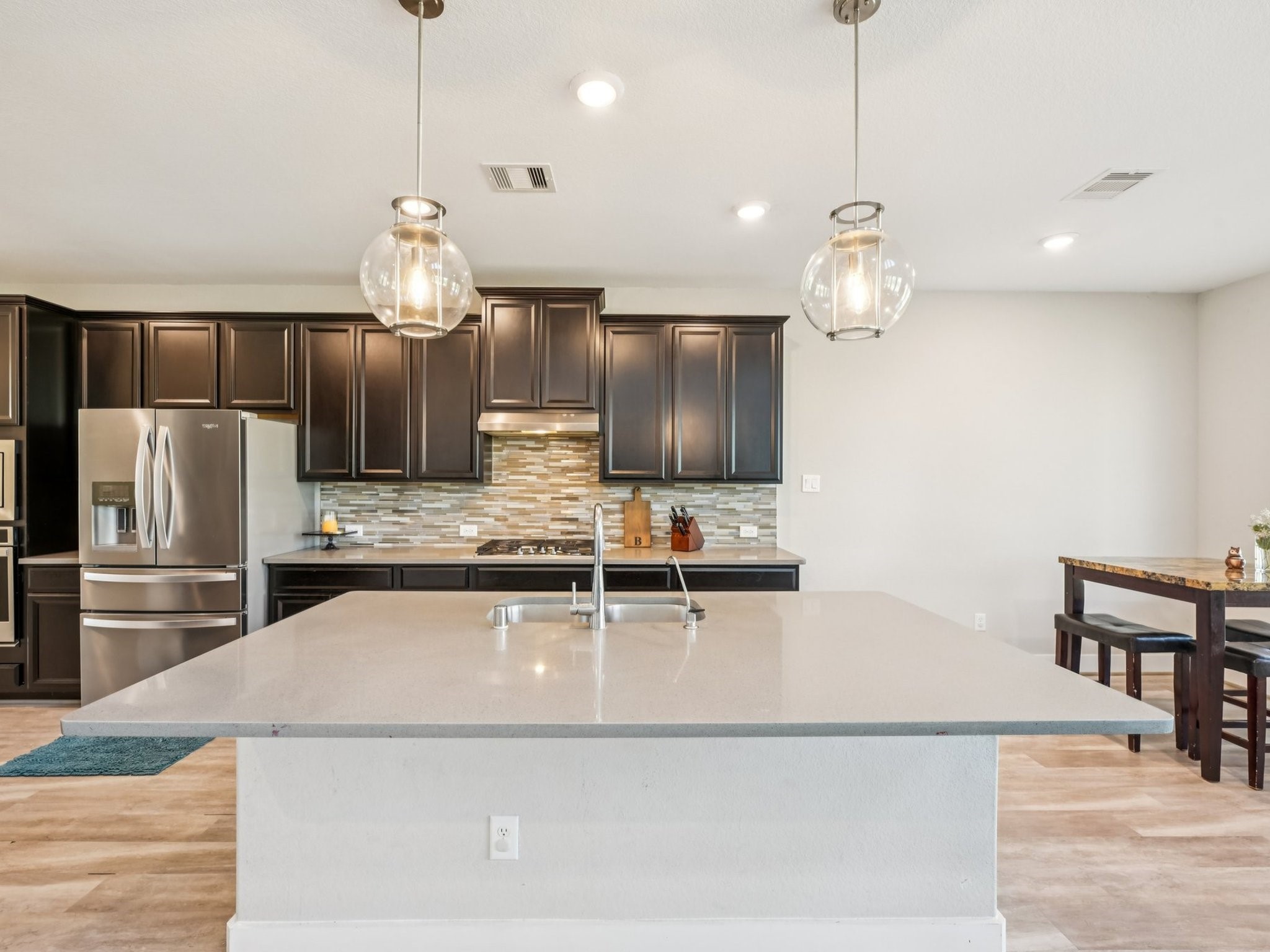 2505 Hatton Terrace Lane Pearland, TX 77089 - Photo 14 of 44 a kitchen with kitchen island granite countertop a sink and refrigerator