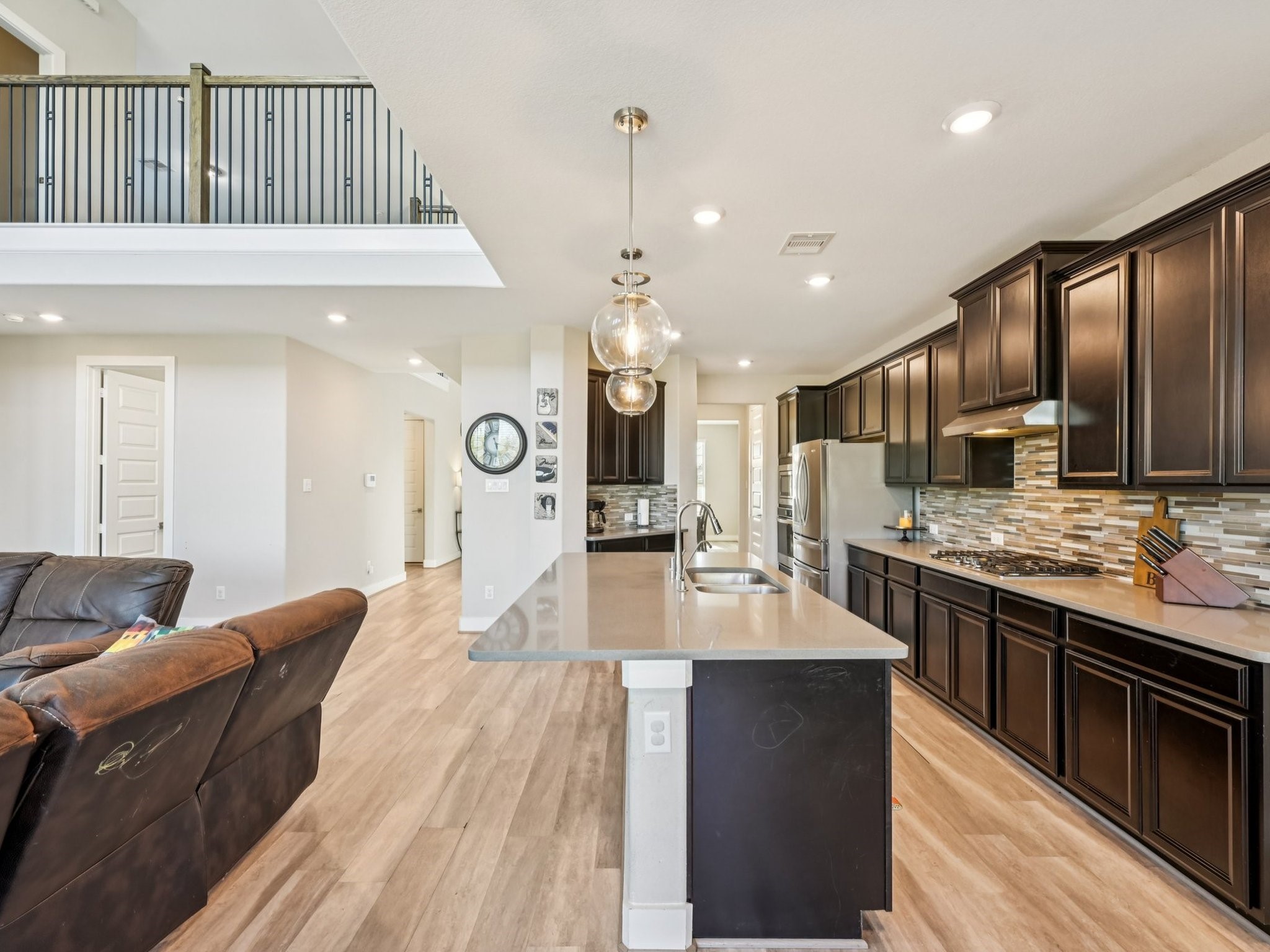 2505 Hatton Terrace Lane Pearland, TX 77089 - Photo 16 of 44 a large kitchen with stainless steel appliances granite countertop a lot of cabinets and wooden floor