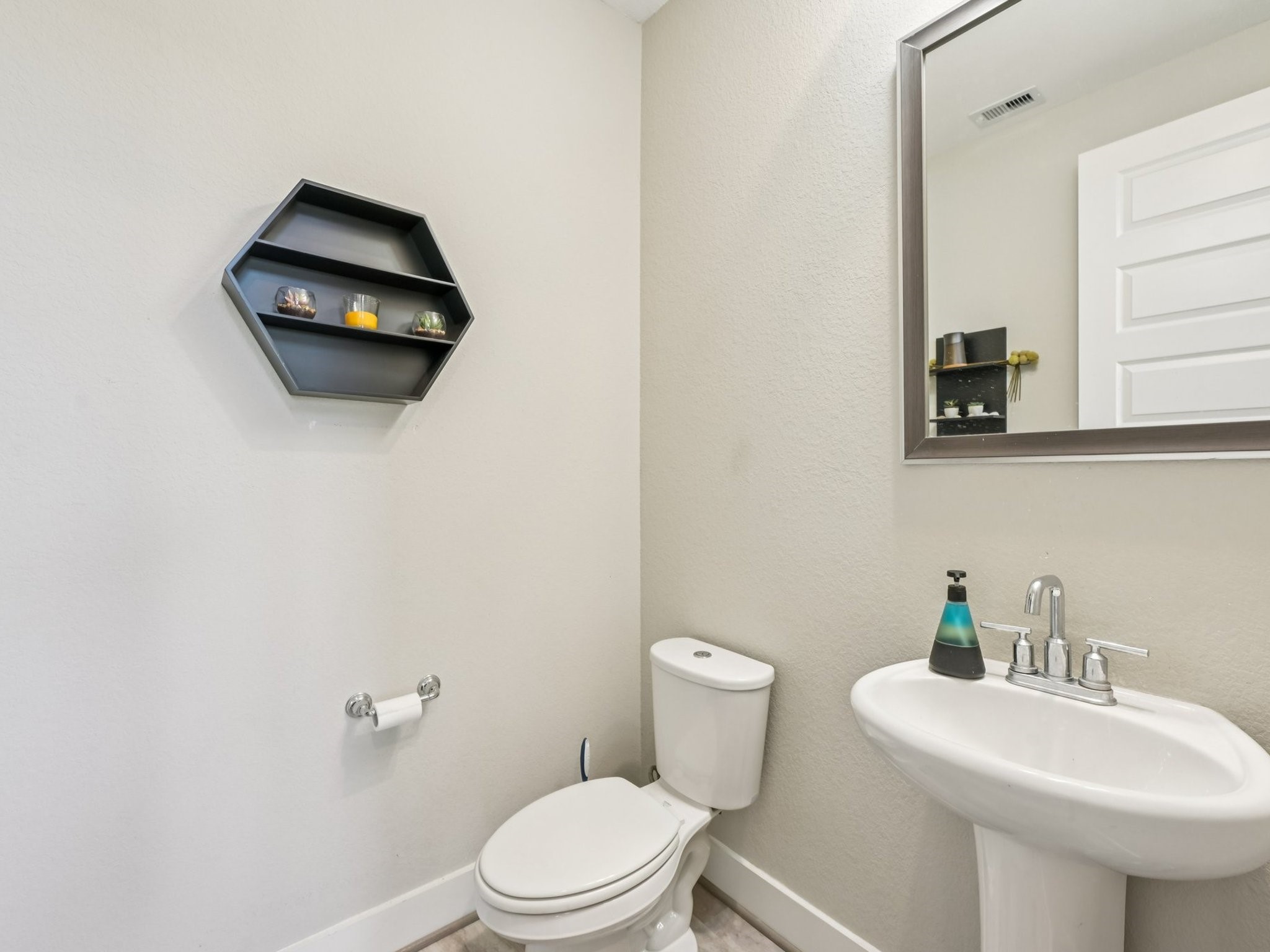 2505 Hatton Terrace Lane Pearland, TX 77089 - Photo 23 of 44 a bathroom with a sink a toilet and mirror