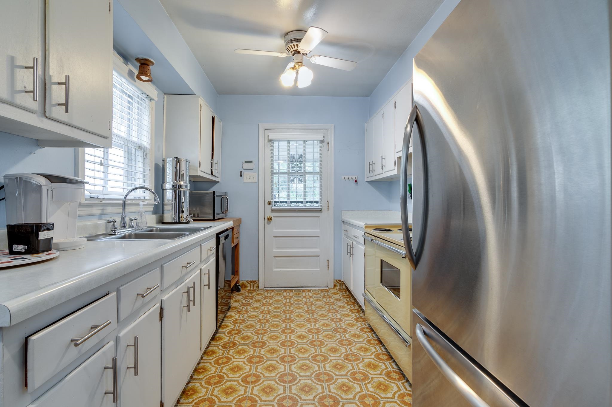 4892 Kaye Road Memphis, TN 38117 - Photo 6 of 17 a kitchen with stainless steel appliances a refrigerator sink and cabinets