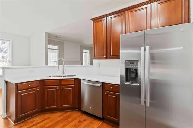 a kitchen with stainless steel appliances granite countertop a refrigerator and a sink