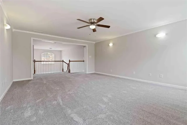 a view of an empty room with a ceiling fan
