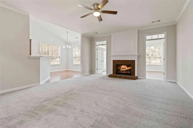 a view of a livingroom with a fireplace and window
