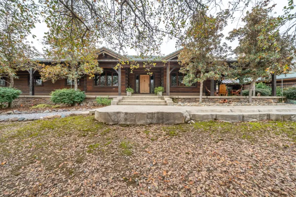a view of a house with a yard and sitting area
