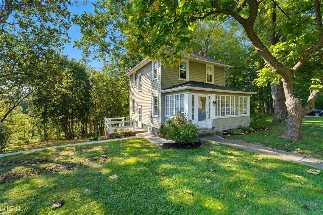 10536 Johnnycake Ridge Road Painesville, OH 44077 - Photo 1 of 40 Traditional style home featuring a front lawn and a chimney