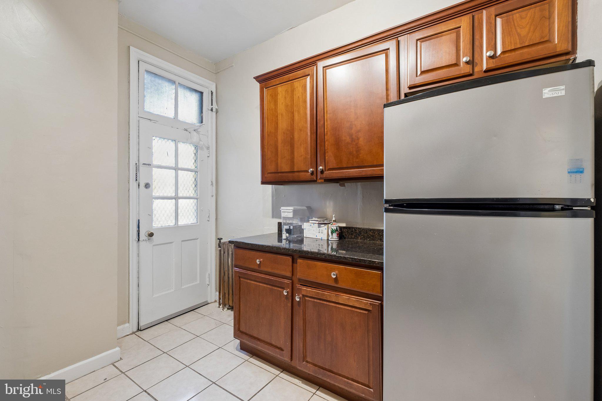 2031 Locust Street, Unit 101 Philadelphia, PA 19103 - Photo 6 of 23 a kitchen with stainless steel appliances granite countertop a refrigerator and a sink