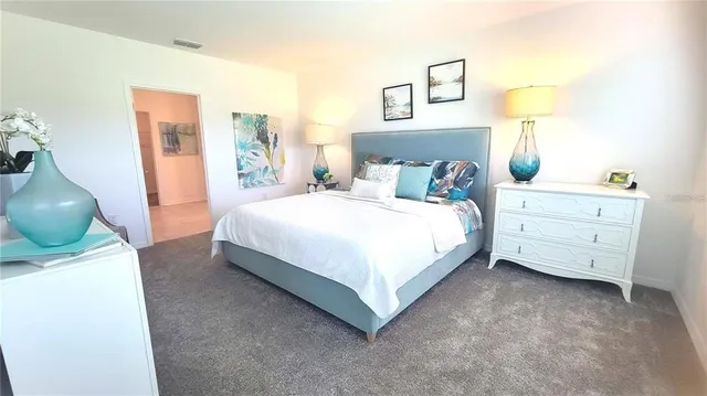 a bedroom with a bed and lamp