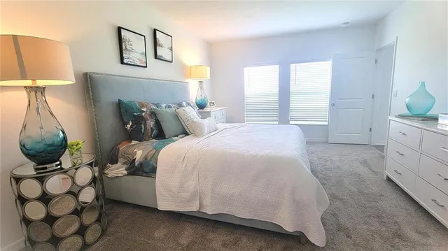 a bedroom with a bed and lamp