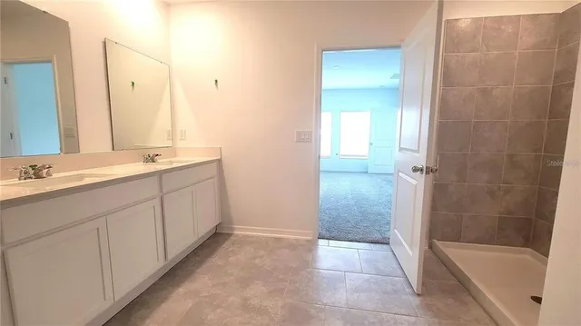 a bathroom with a tub sink and mirror