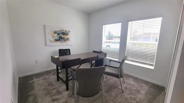 a view of a dining room with furniture and window