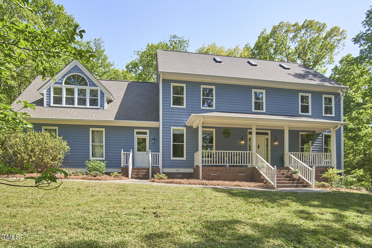 8407 Millers Bend Bahama, NC 27503 - Photo 2 of 77 a front view of a house with a yard