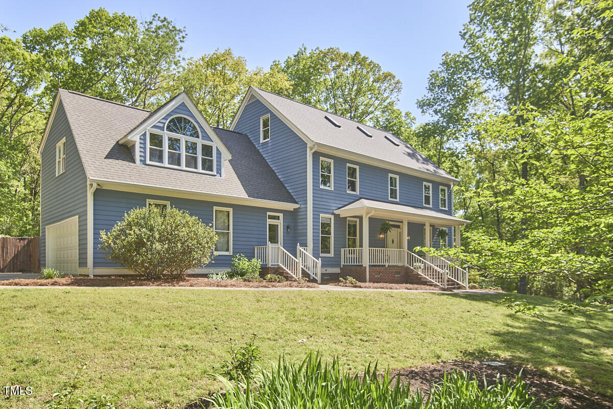 8407 Millers Bend Bahama, NC 27503 - Photo 3 of 77 a front view of a house with garden