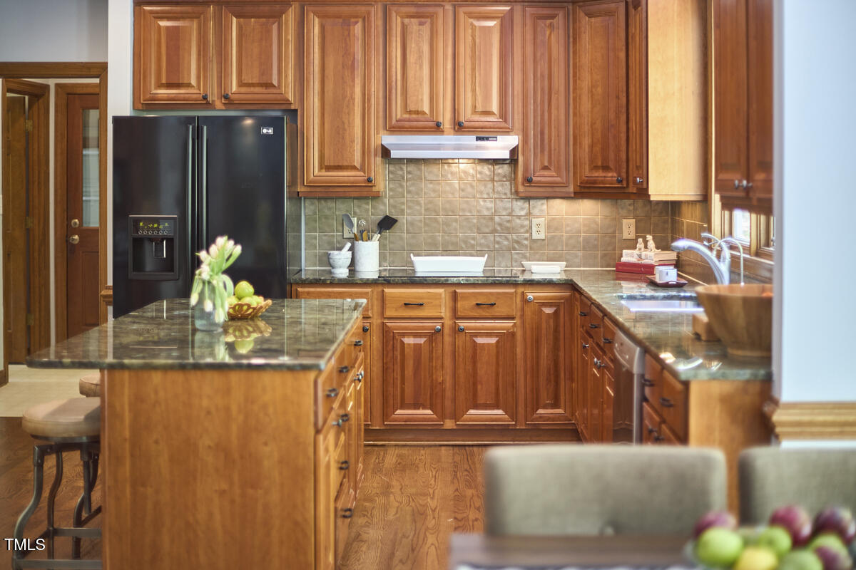 8407 Millers Bend Bahama, NC 27503 - Photo 31 of 77 a kitchen with stainless steel appliances granite countertop a refrigerator and a stove
