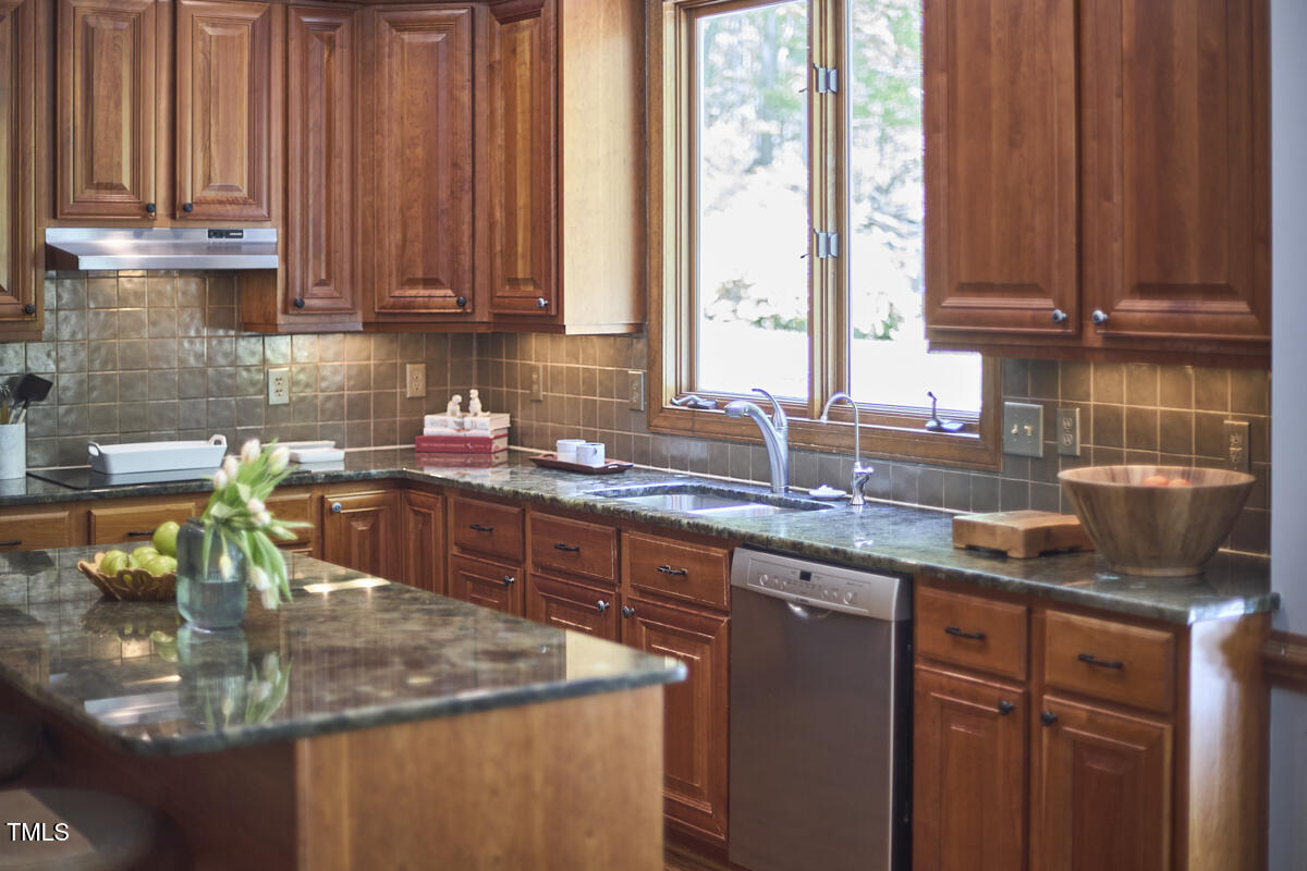 8407 Millers Bend Bahama, NC 27503 - Photo 32 of 77 a kitchen with stainless steel appliances granite countertop a sink a stove and dishwasher