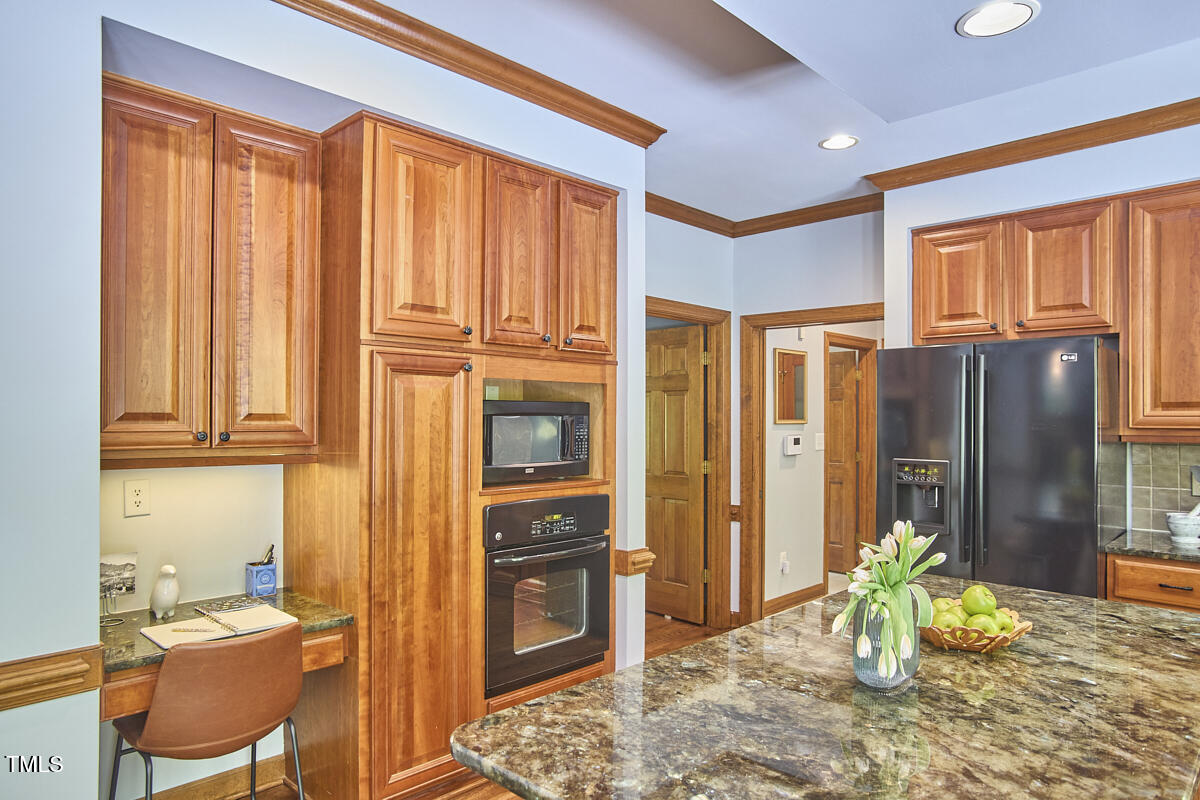8407 Millers Bend Bahama, NC 27503 - Photo 35 of 77 a view of a kitchen with refrigerator and dining table