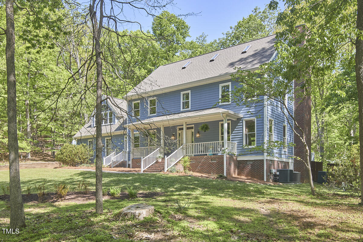 8407 Millers Bend Bahama, NC 27503 - Photo 4 of 77 front view of a house with a yard