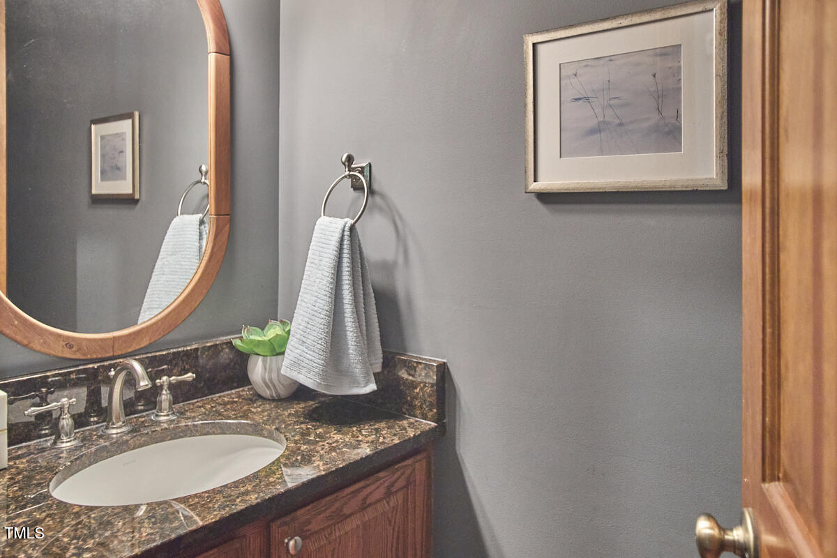 8407 Millers Bend Bahama, NC 27503 - Photo 41 of 77 a bathroom with a granite countertop sink and a mirror