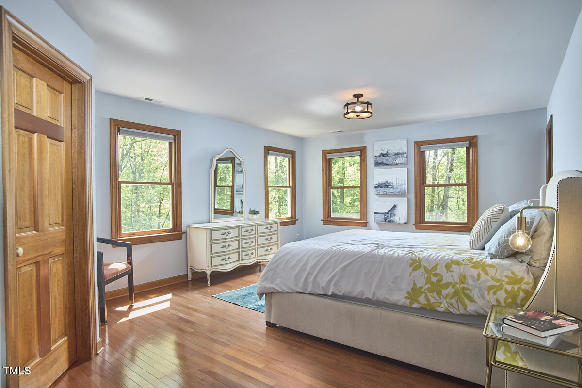 8407 Millers Bend Bahama, NC 27503 - Photo 44 of 77 a bedroom with a bed and wooden floor