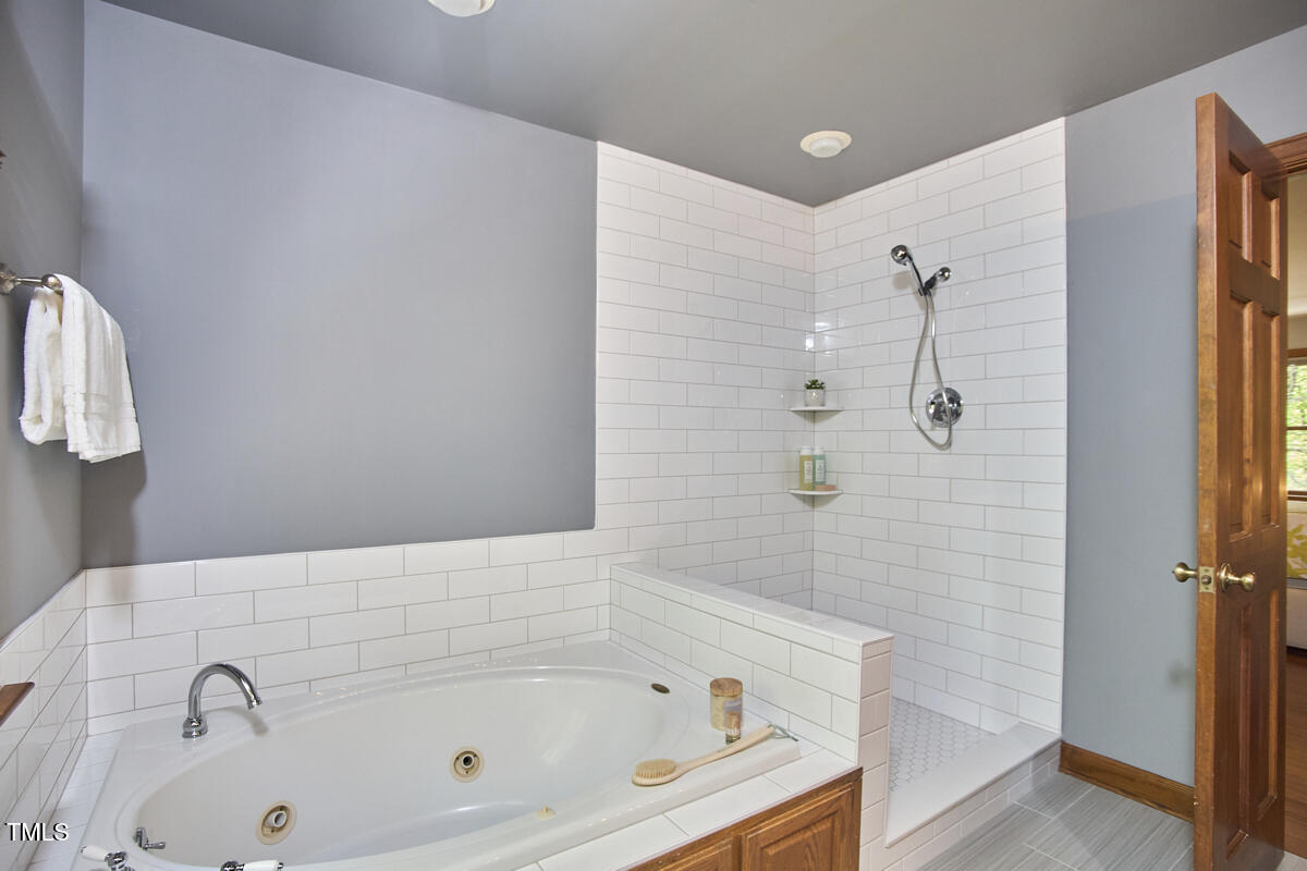 8407 Millers Bend Bahama, NC 27503 - Photo 47 of 77 a bathroom with a tub and shower