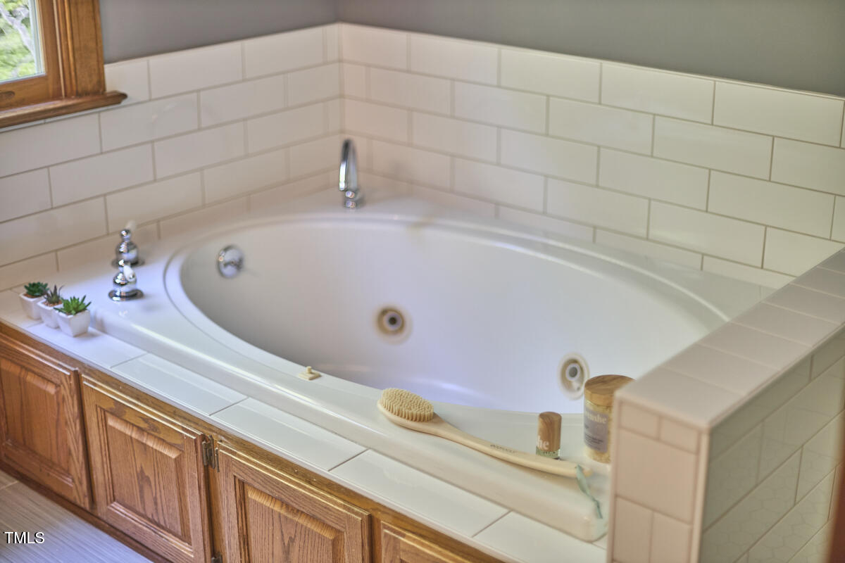 8407 Millers Bend Bahama, NC 27503 - Photo 48 of 77 a bathroom with a tub and a sink