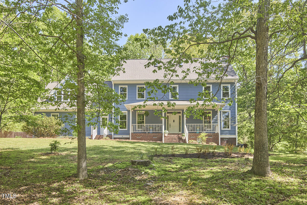 8407 Millers Bend Bahama, NC 27503 - Photo 5 of 77 a view of a house with a yard deck and a large tree