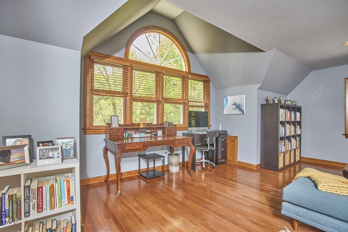 8407 Millers Bend Bahama, NC 27503 - Photo 57 of 77 a view of a livingroom with furniture and a book shelf