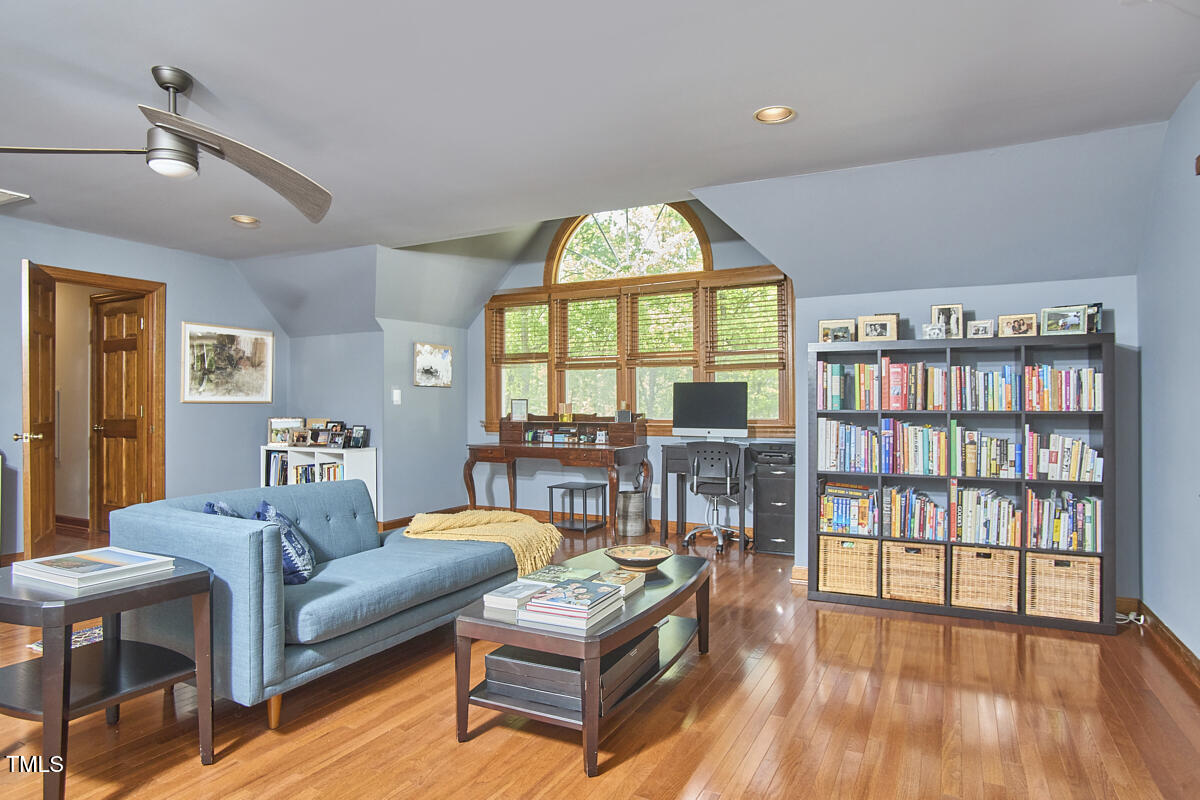8407 Millers Bend Bahama, NC 27503 - Photo 60 of 77 a living room with furniture hard wood floor and a book shelf