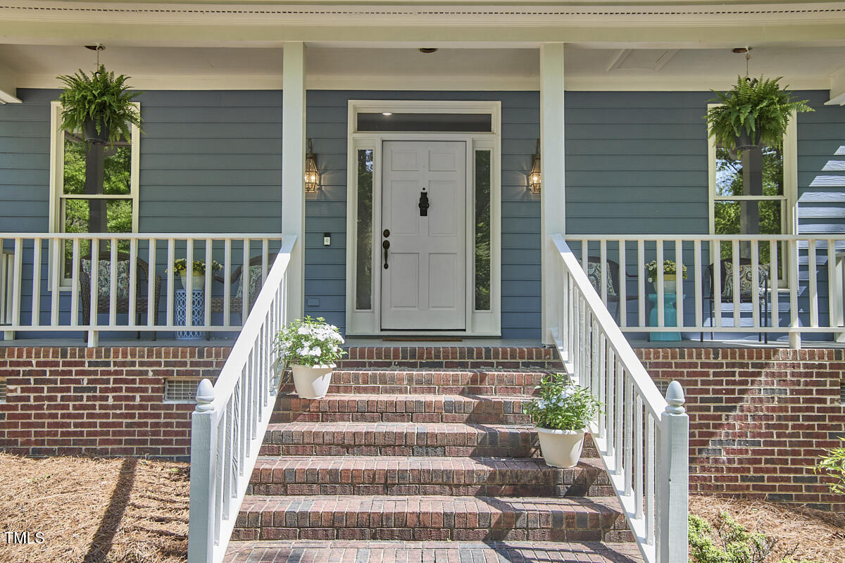 8407 Millers Bend Bahama, NC 27503 - Photo 6 of 77 a view of stairs with wooden floor and a potted plant