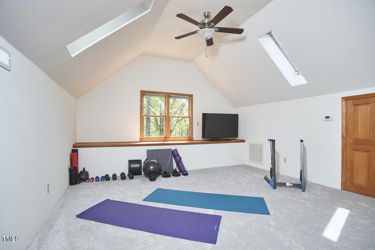 8407 Millers Bend Bahama, NC 27503 - Photo 63 of 77 a room with a bed and a flat screen tv