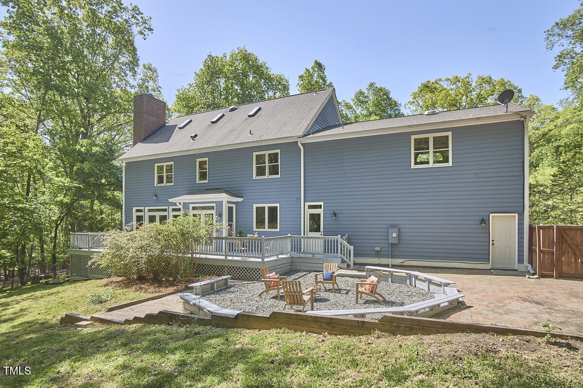8407 Millers Bend Bahama, NC 27503 - Photo 66 of 77 a backyard of a house with yard furniture and outdoor kitchen