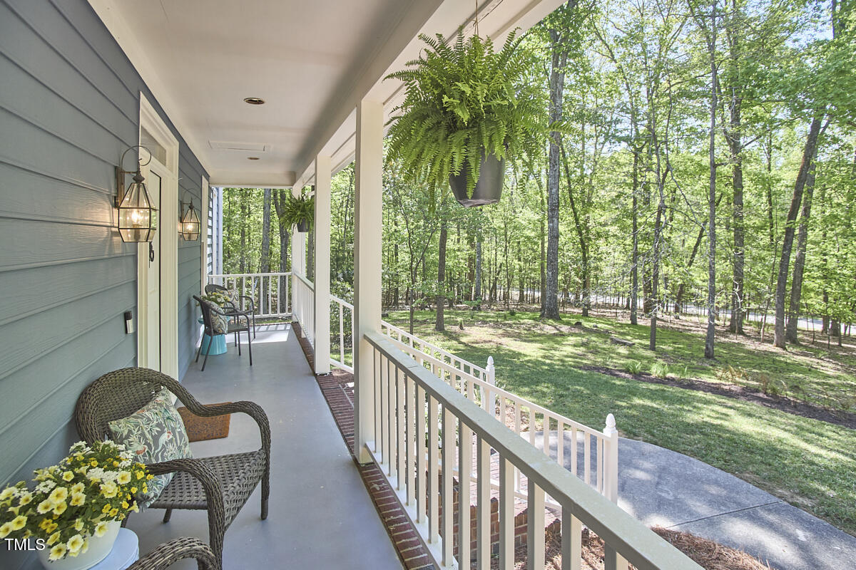 8407 Millers Bend Bahama, NC 27503 - Photo 7 of 77 a view of a chairs and table in patio with wooden fence