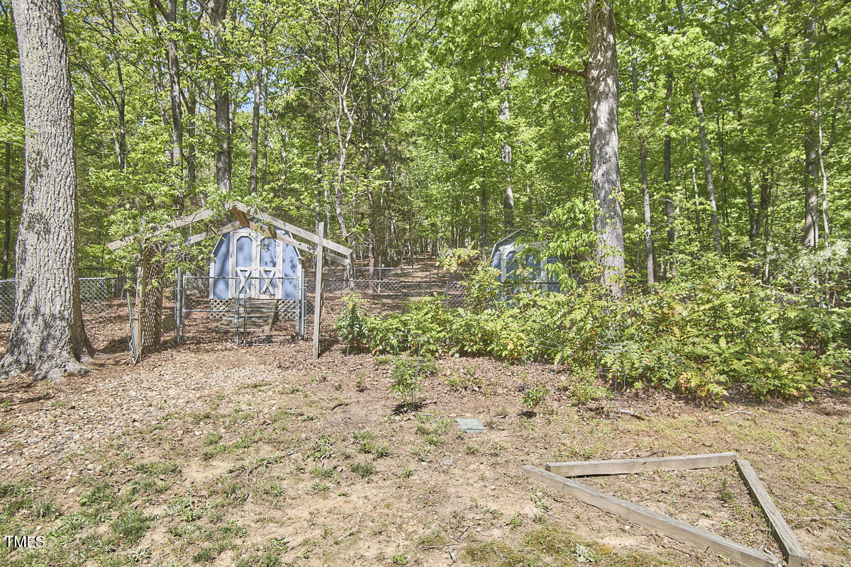8407 Millers Bend Bahama, NC 27503 - Photo 77 of 77 a backyard of a house with large trees and plants