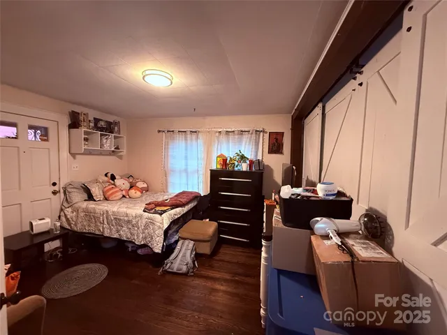 a bedroom with furniture and a wooden floor